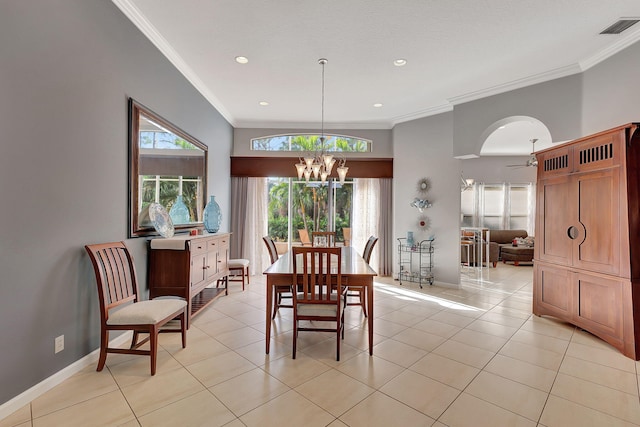 dining area with ceiling fan with notable chandelier, light tile patterned flooring, and crown molding