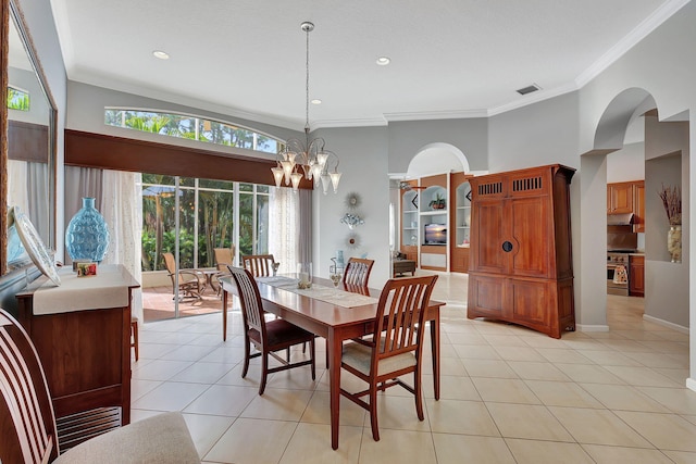 tiled dining space featuring crown molding, a chandelier, and a high ceiling