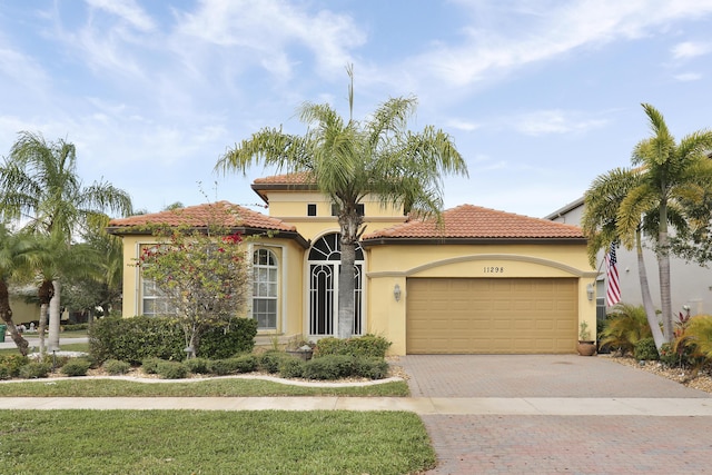 mediterranean / spanish-style home featuring a garage