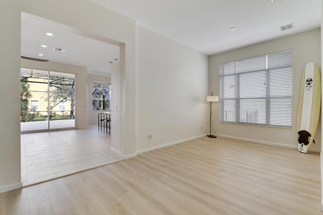 empty room with light hardwood / wood-style flooring