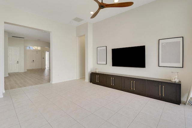 unfurnished living room with ceiling fan and light tile patterned floors