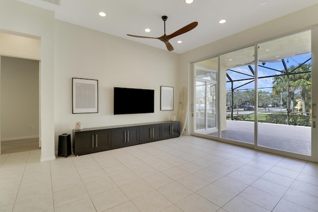 unfurnished living room featuring light tile patterned floors and ceiling fan