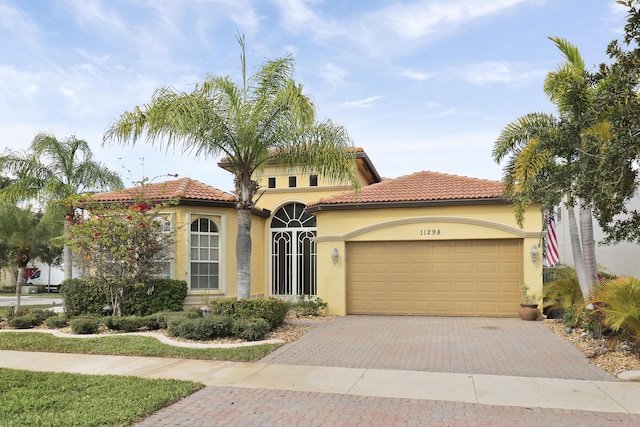 mediterranean / spanish house with a garage