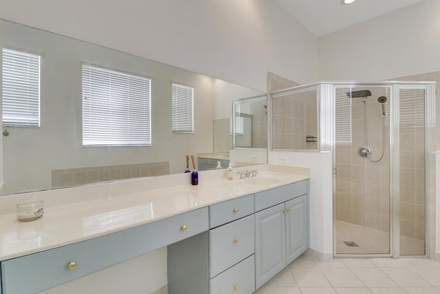 bathroom with tile patterned flooring, vanity, and a shower with shower door