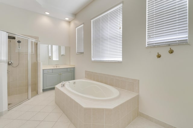 bathroom featuring tile patterned flooring, vanity, and plus walk in shower