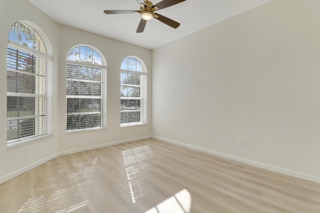 spare room with light wood-type flooring and ceiling fan