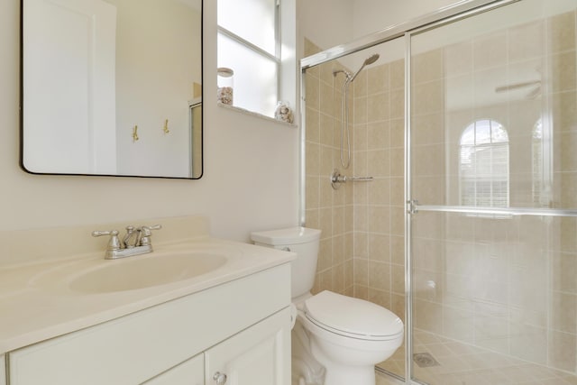 bathroom featuring a wealth of natural light, vanity, and a shower with shower door