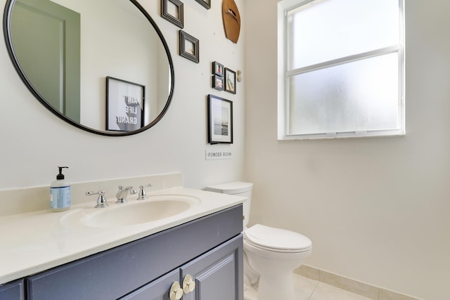 bathroom with tile patterned flooring, vanity, and toilet