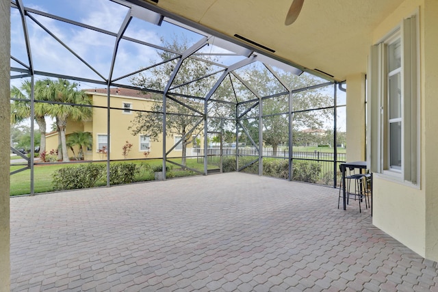 view of patio featuring a lanai