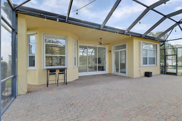 unfurnished sunroom featuring ceiling fan