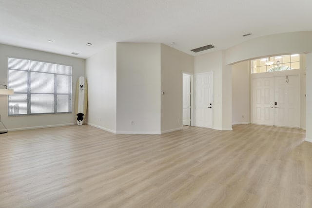 unfurnished living room featuring light hardwood / wood-style flooring and a wealth of natural light