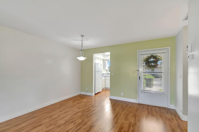 unfurnished room with light hardwood / wood-style floors