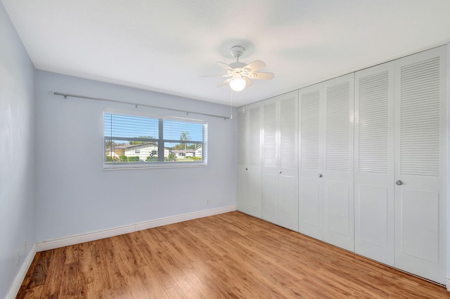 unfurnished bedroom with a closet, light hardwood / wood-style flooring, and ceiling fan