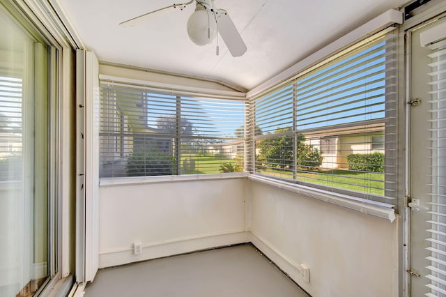 unfurnished sunroom featuring plenty of natural light and vaulted ceiling