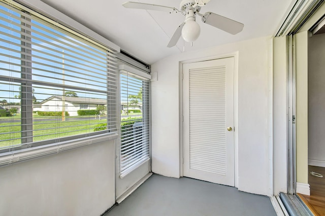 unfurnished sunroom featuring ceiling fan