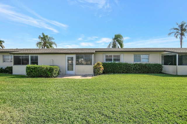 ranch-style home featuring a front yard