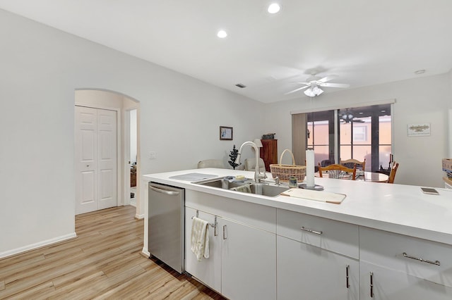 kitchen with dishwasher, sink, ceiling fan, light wood-type flooring, and white cabinetry