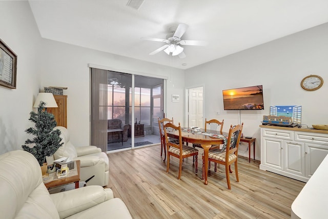 dining space with ceiling fan and light wood finished floors