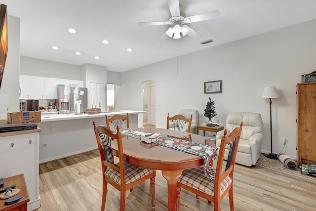 dining space with arched walkways, ceiling fan, light wood-style flooring, recessed lighting, and visible vents