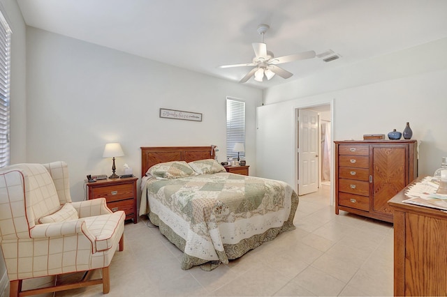 bedroom with multiple windows, ceiling fan, and light tile patterned flooring