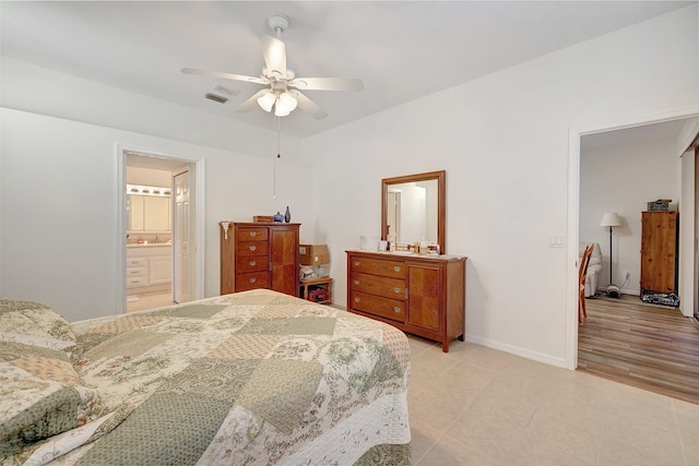 bedroom with ceiling fan, light hardwood / wood-style floors, and ensuite bathroom