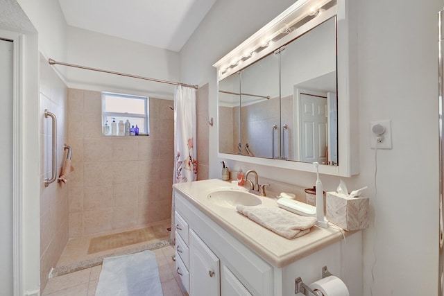 bathroom featuring tile patterned flooring, vanity, and curtained shower