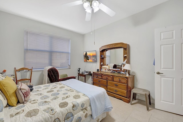 tiled bedroom featuring multiple windows and ceiling fan