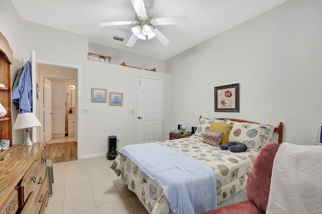 bedroom with ceiling fan and light tile patterned flooring