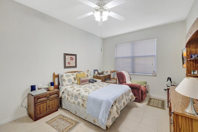 bedroom with a ceiling fan and baseboards