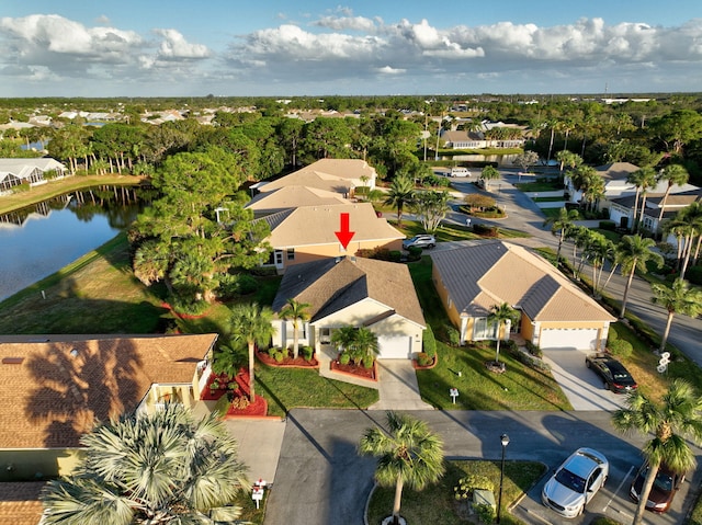 drone / aerial view featuring a residential view and a water view