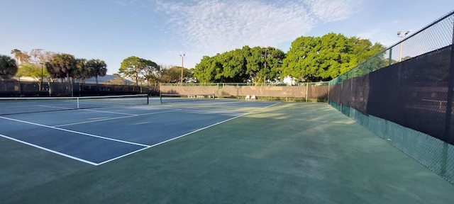 view of sport court featuring fence