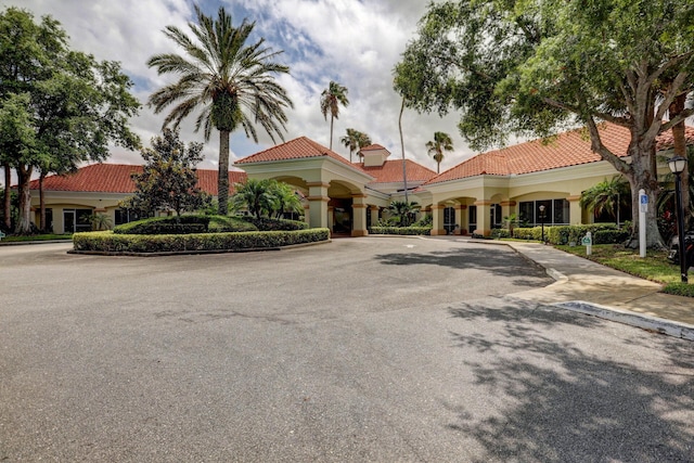 view of front of home with a tile roof and stucco siding