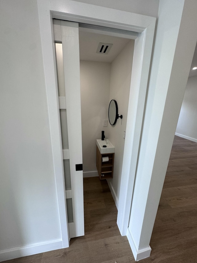 bathroom with hardwood / wood-style flooring