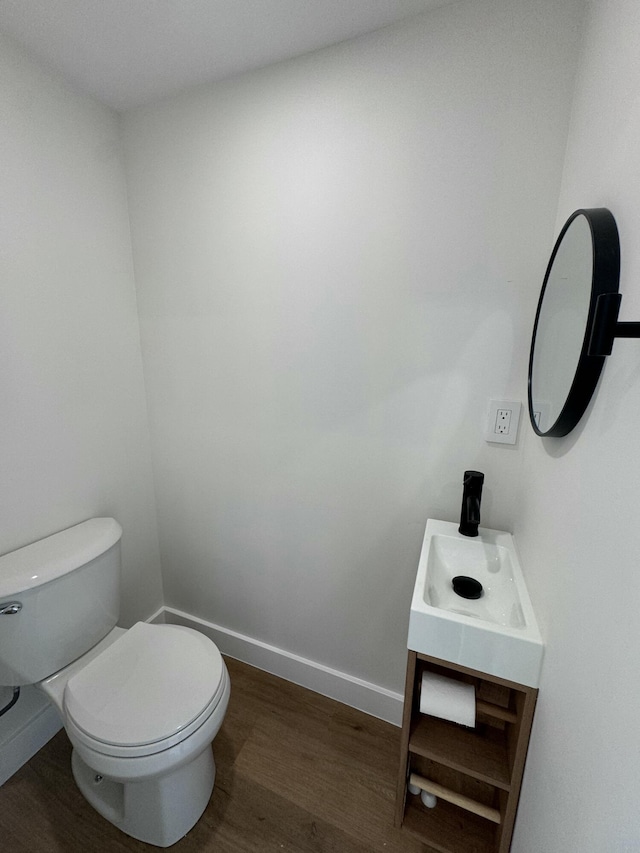 bathroom featuring hardwood / wood-style floors, vanity, and toilet