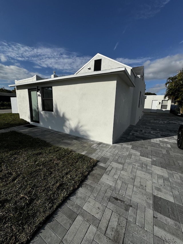 view of property exterior featuring a patio area