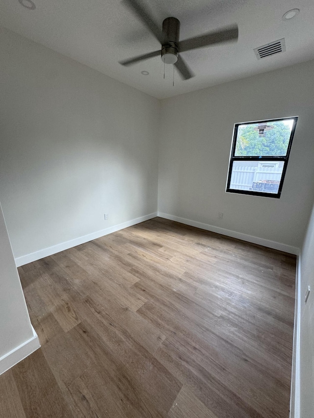 empty room featuring ceiling fan and light wood-type flooring