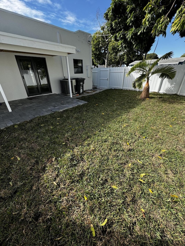 view of yard with a patio area and central air condition unit