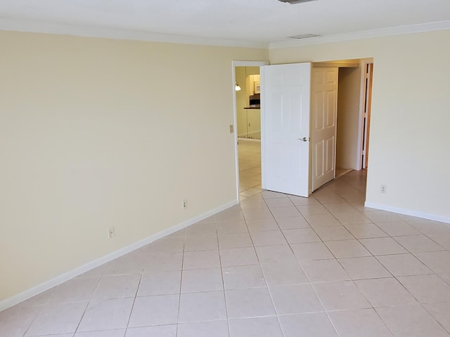 tiled empty room with crown molding