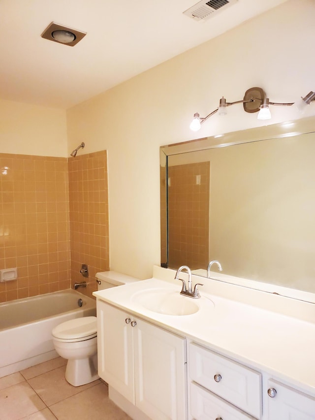 full bathroom featuring tile patterned flooring, vanity, tiled shower / bath combo, and toilet