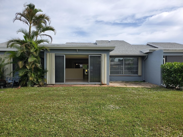 rear view of house with a yard