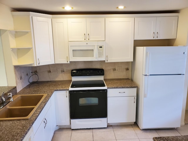 kitchen featuring backsplash, sink, white cabinets, and white appliances