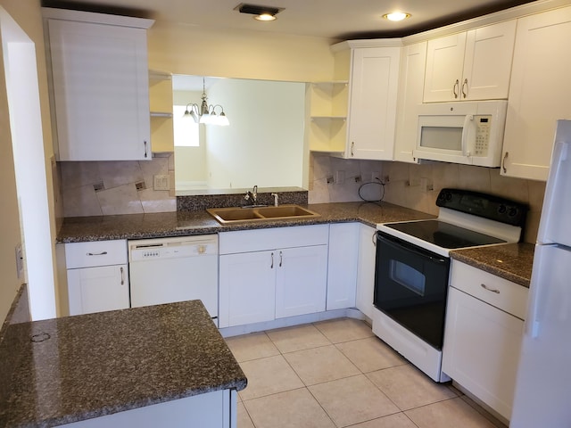 kitchen with white cabinets, white appliances, sink, and an inviting chandelier