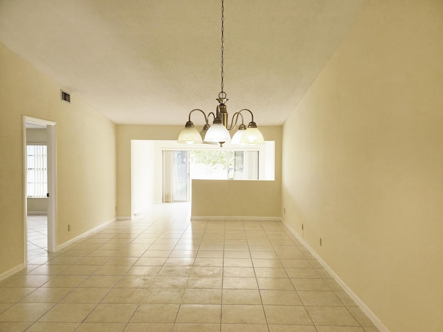 unfurnished dining area featuring an inviting chandelier, a healthy amount of sunlight, and light tile patterned flooring