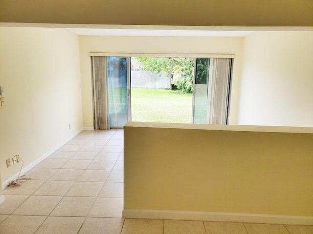 unfurnished room with light tile patterned floors