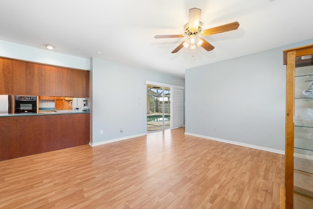 unfurnished living room with ceiling fan and light hardwood / wood-style floors