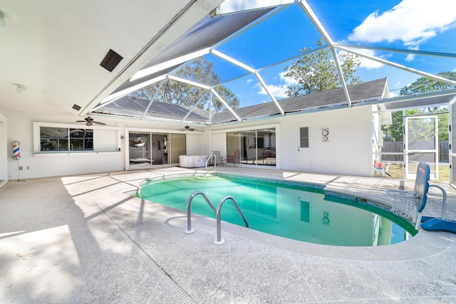 view of swimming pool with glass enclosure and a patio