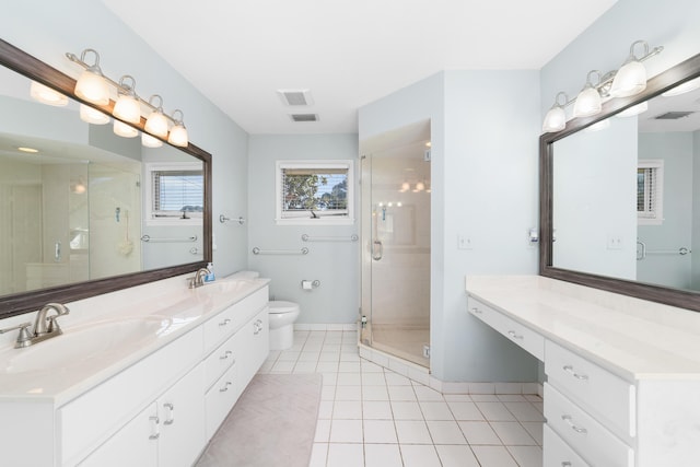 bathroom featuring tile patterned flooring, toilet, an enclosed shower, and vanity