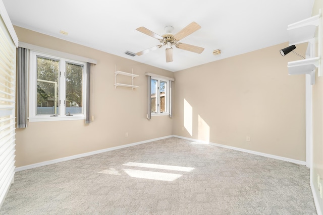 carpeted spare room with ceiling fan