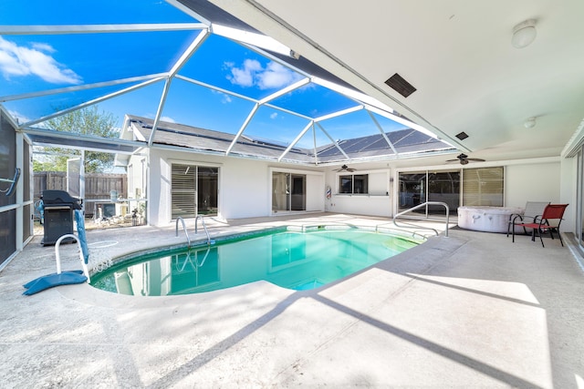 view of pool with ceiling fan, a lanai, a grill, a patio, and a hot tub