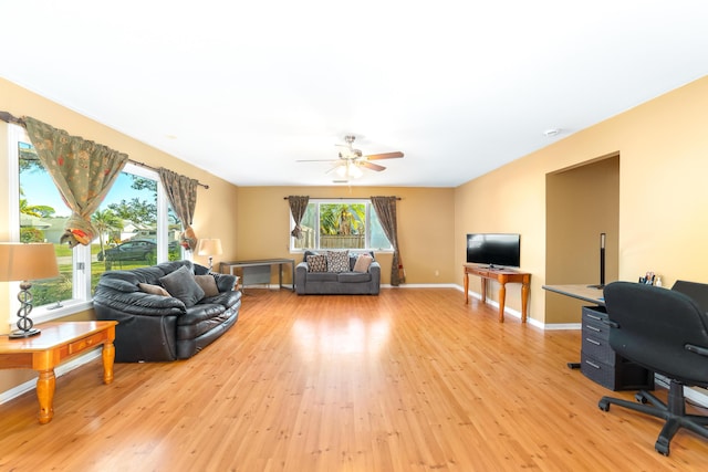 living room featuring ceiling fan and light hardwood / wood-style floors